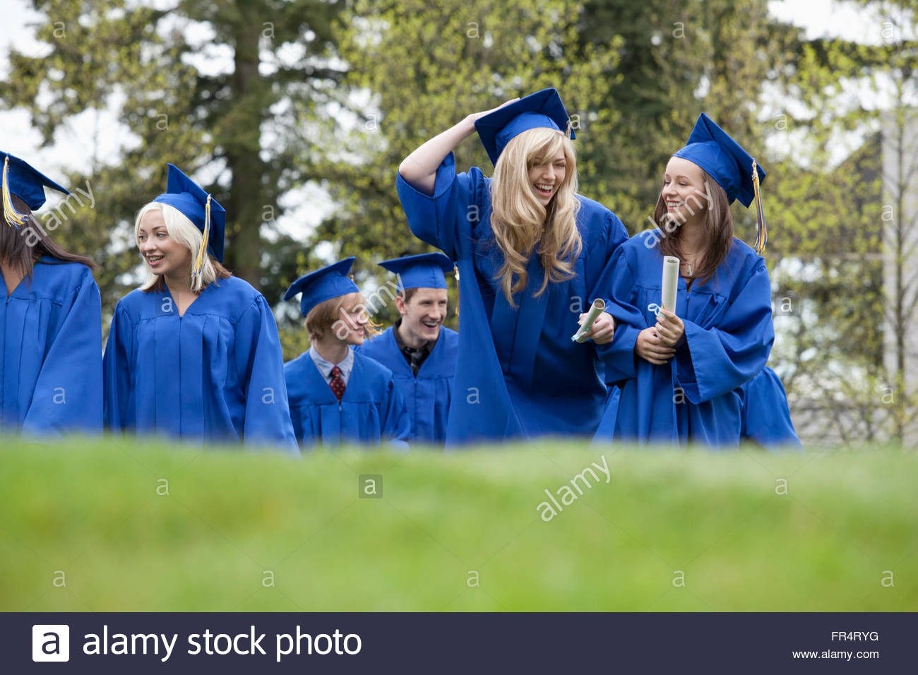 graduates walking together outside Stock Photo Alamy