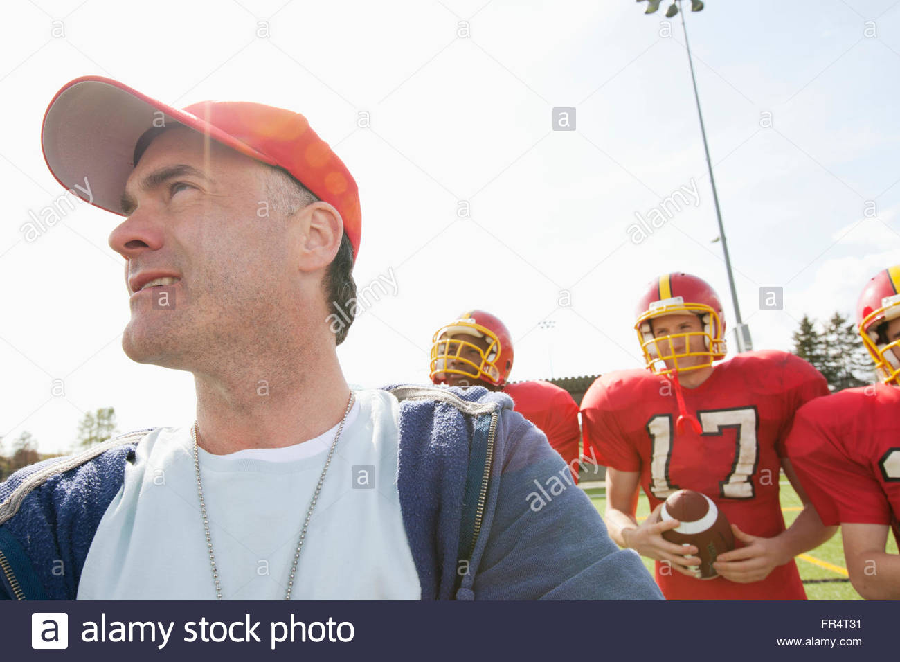 coach with college football players Stock Photo