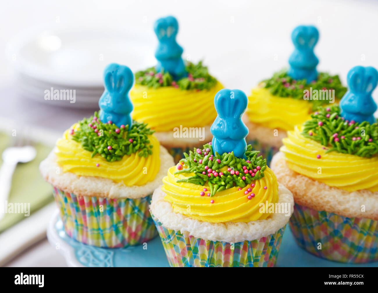 Vanilla cupcakes with yellow buttercream decorated for Easter Stock