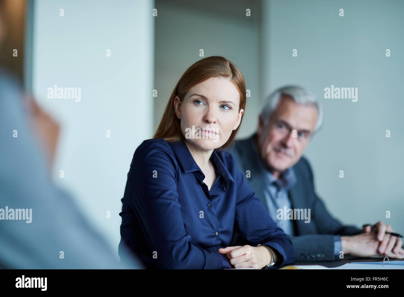 Attentive businesswoman listening in meeting Stock Photo