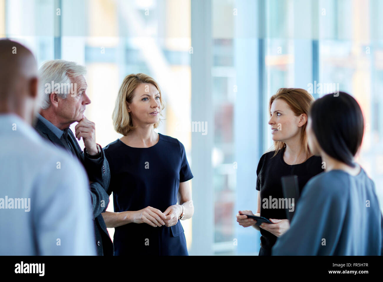 Business people talking in lobby Stock Photo