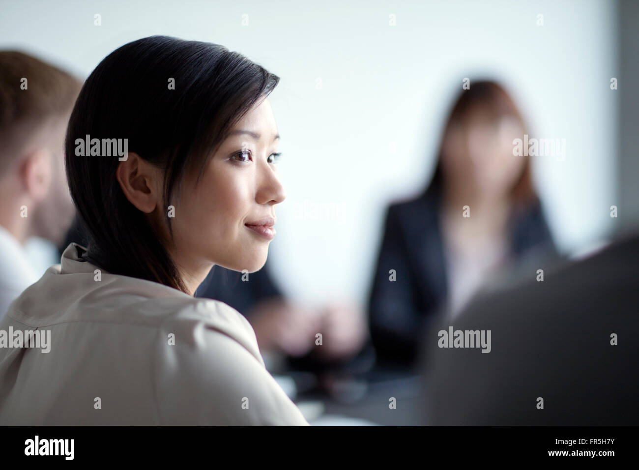 Attentive businesswoman listening in meeting Stock Photo