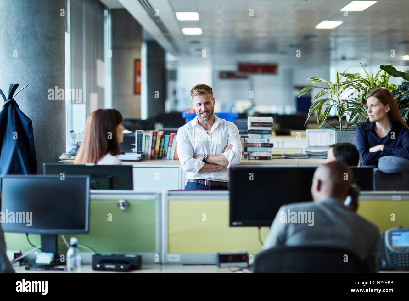 Business people talking in office cubicle Stock Photo