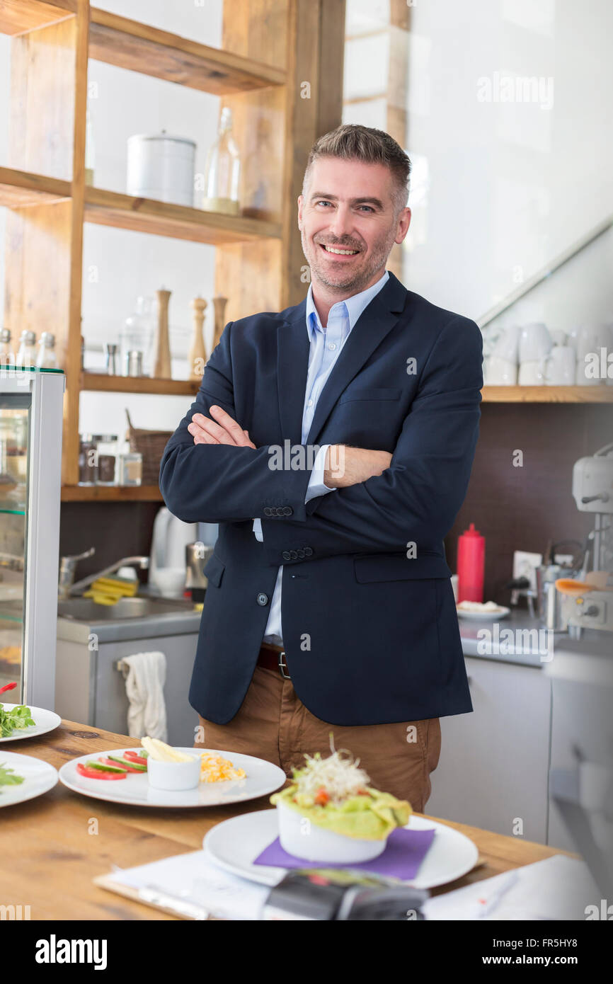 Portrait smiling restaurant owner behind the counter Stock Photo