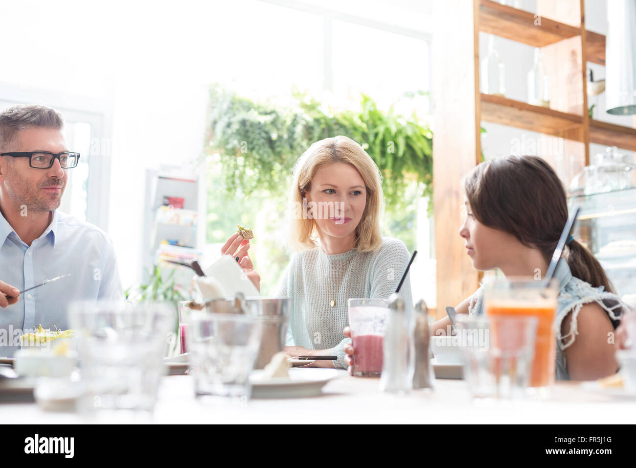 Family eating lunch at cafe table Stock Photo