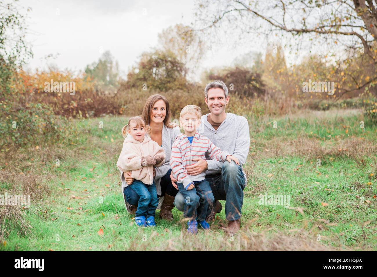 Portrait smiling family in rural park Stock Photo