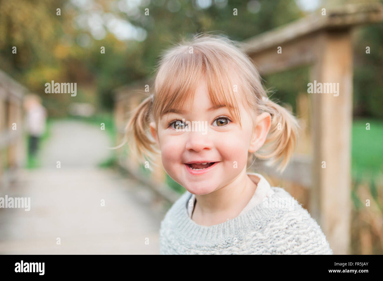 Portrait smiling toddler girl with pigtails Stock Photo