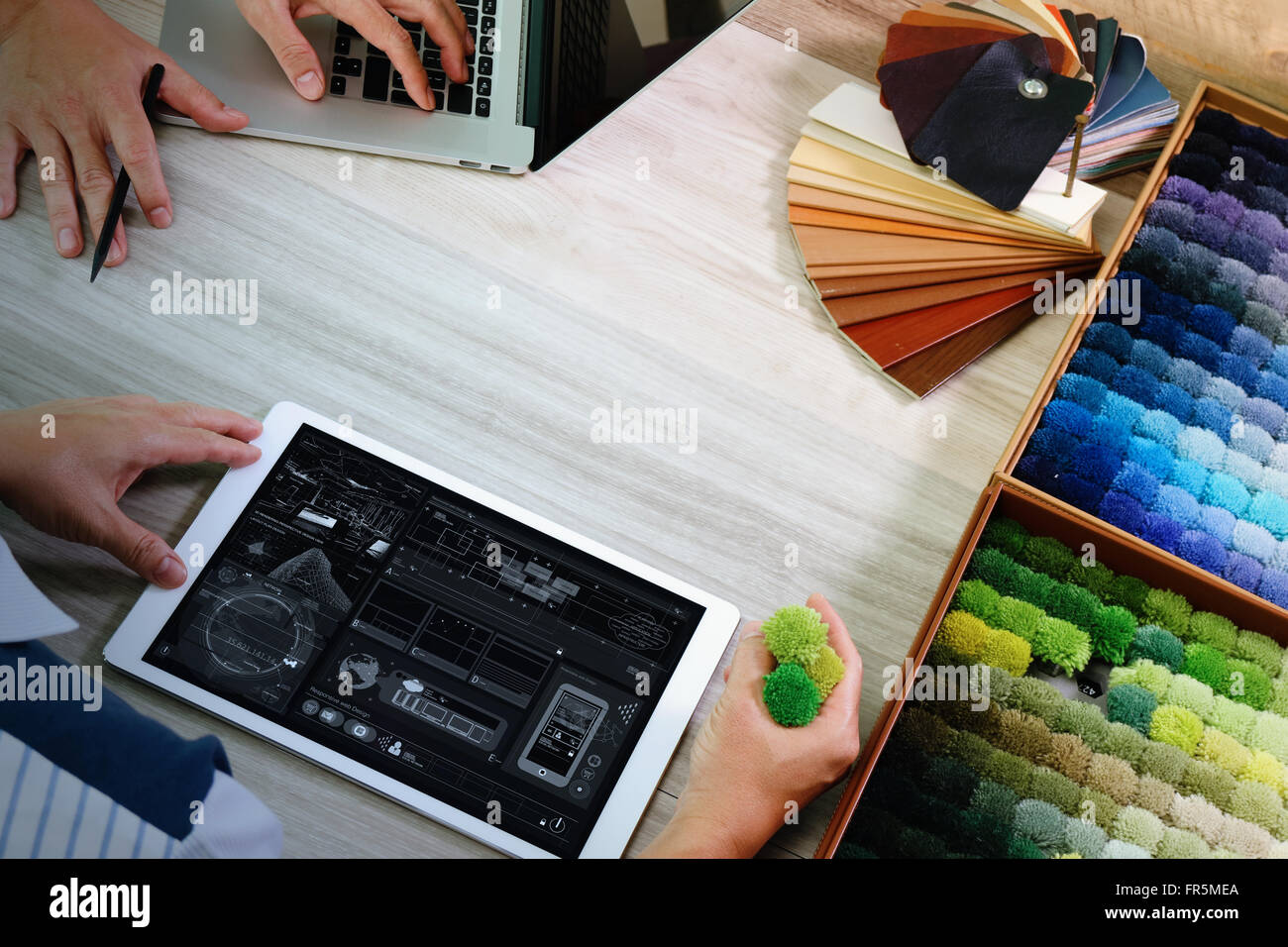 top view of two colleagues interior designers discussing data with ...