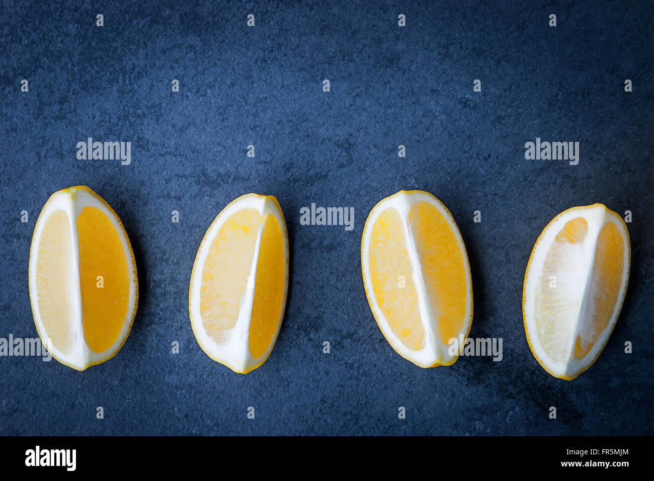 Horizontal Lemon Slices of lemon on a stone table horizontal Stock Photo - Alamy