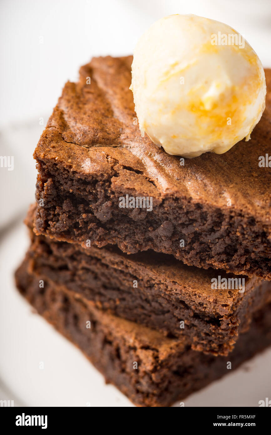Brownie with ice cream on a white ceramic plate vertical Stock Photo ...