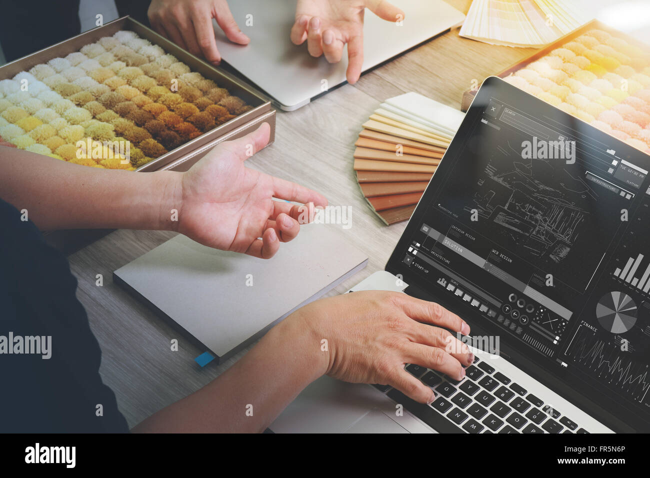 top view of two colleagues interior designers discussing data with ...