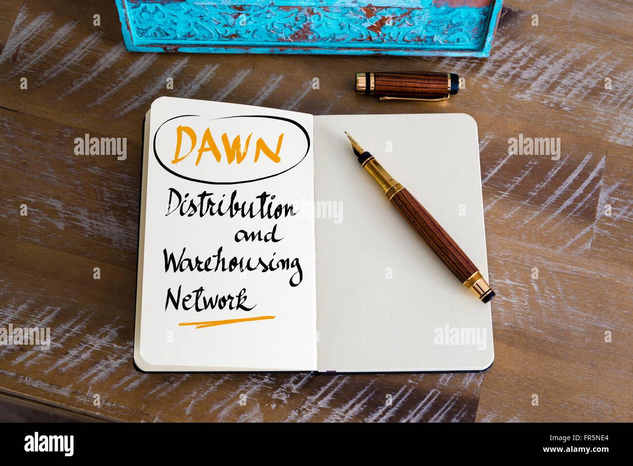 Retro effect and toned image of a fountain pen on a notebook. Business Acronym DAWN as Distribution and Warehousing Network as business concept image Stock Photo