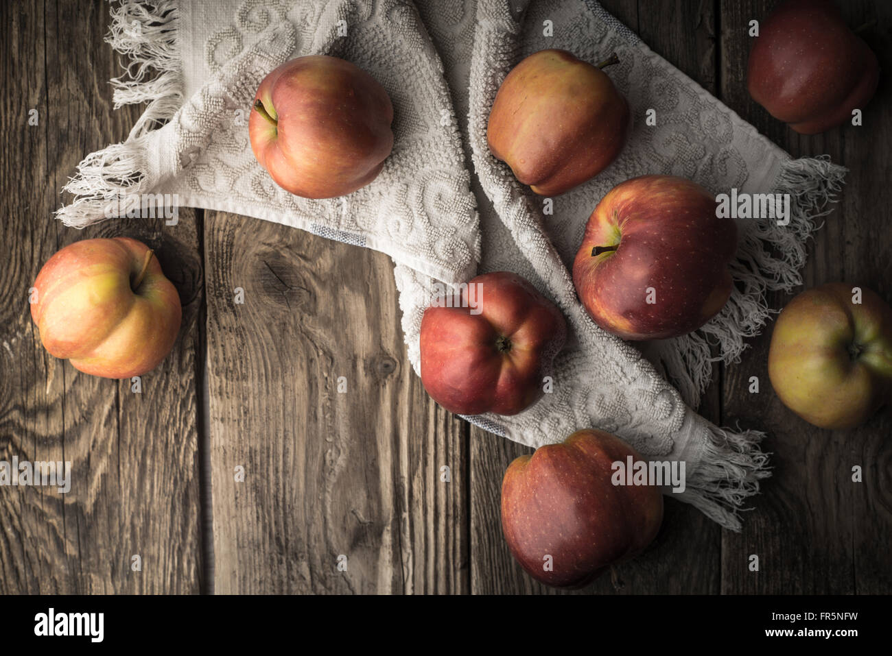 Red apples and towel on the old boards horizontal Stock Photo