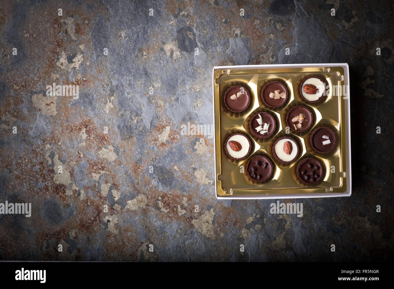 Set of chocolate candies on a blue stone horizontal Stock Photo