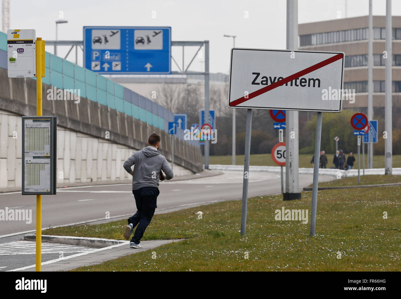 Brussels, Belgium. 22nd Mar, 2016. A man runs at Brussels airport in Brussels, Belgium, on March 22, 2016. At least 13 people were reportedly dead after explosions at Brussels airport and a metro station on Tuesday. Credit:  Ye Pingfan/Xinhua/Alamy Live News Stock Photo