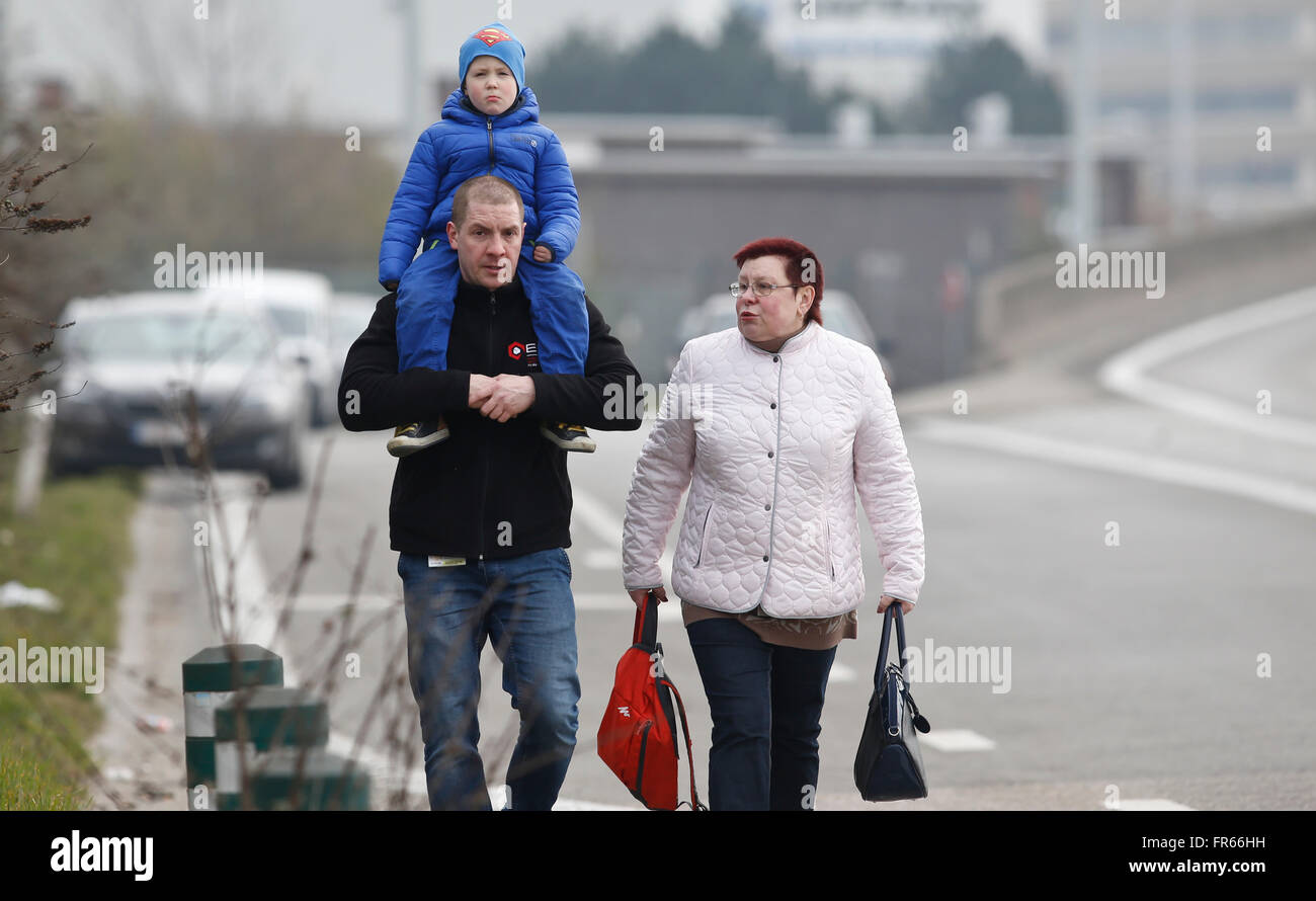 Brussels, Belgium. 22nd Mar, 2016. People are evacuated from Brussels airport in Brussels, Belgium, on March 22, 2016. At least 13 people were reportedly dead after explosions at Brussels airport and a metro station on Tuesday. Credit:  Ye Pingfan/Xinhua/Alamy Live News Stock Photo