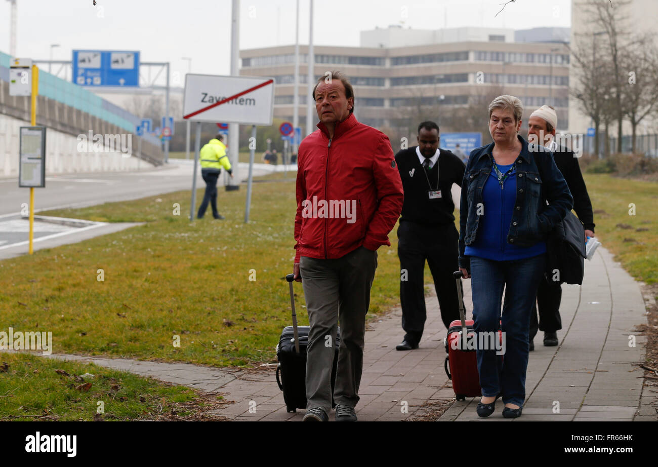 Brussels, Belgium. 22nd Mar, 2016. People are evacuated from Brussels airport in Brussels, Belgium, on March 22, 2016. At least 13 people were reportedly dead after explosions at Brussels airport and a metro station on Tuesday. Credit:  Ye Pingfan/Xinhua/Alamy Live News Stock Photo