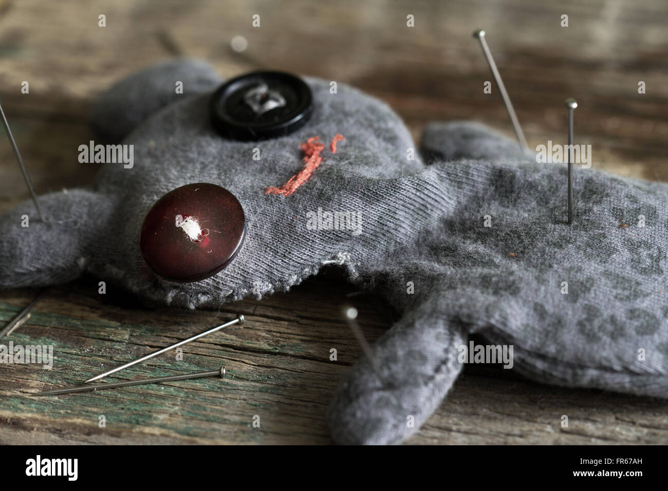 Voodoo doll and pins on old vintage wooden floor closeup Stock Photo ...