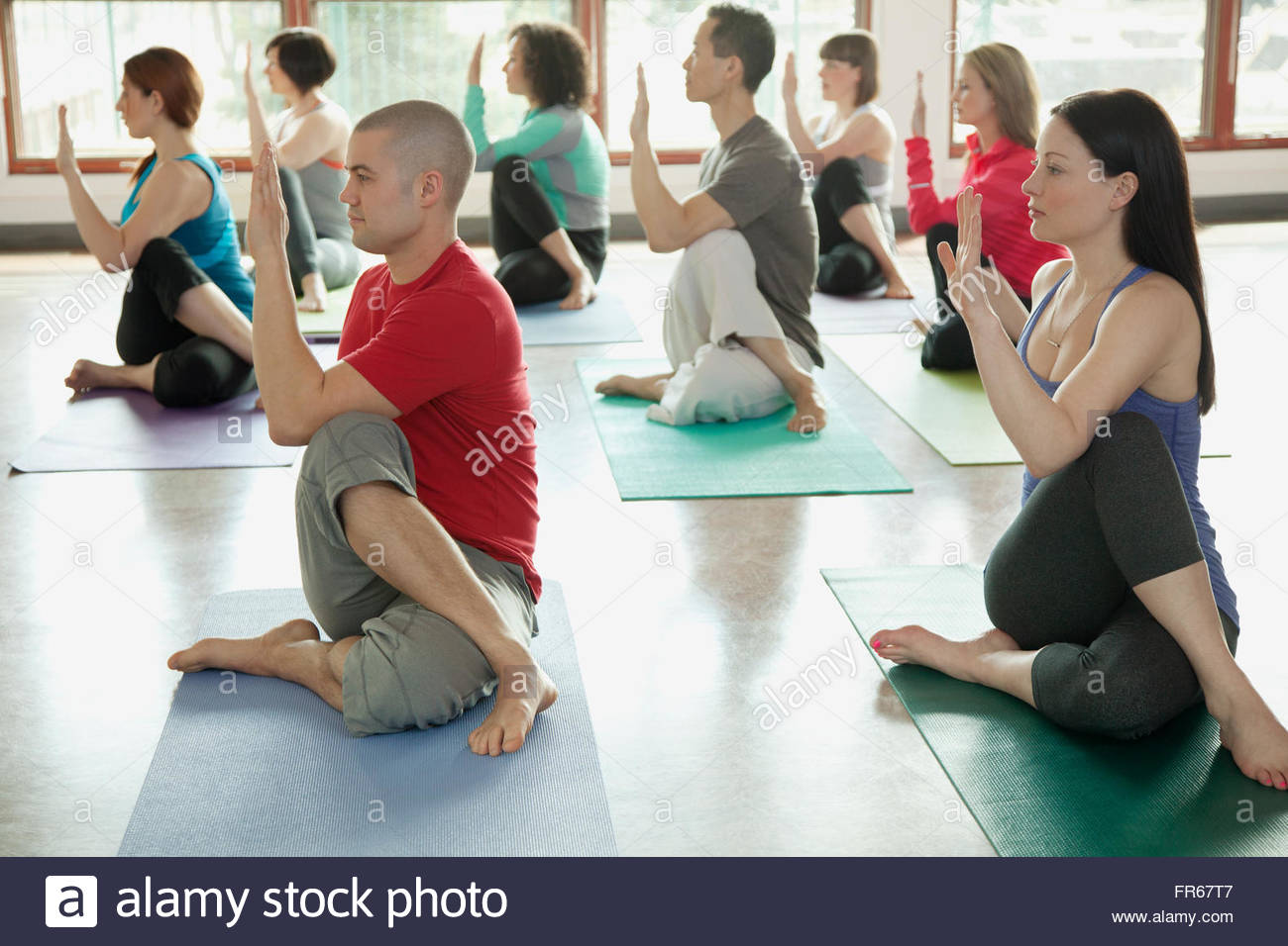 Yoga class doing Half Lord of the Fishes Stock Photo