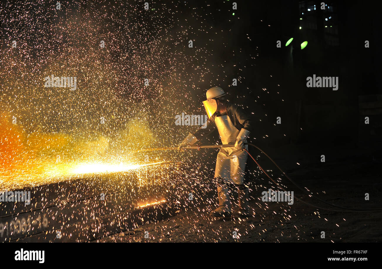 Industrial welder inside of steel plant Stock Photo