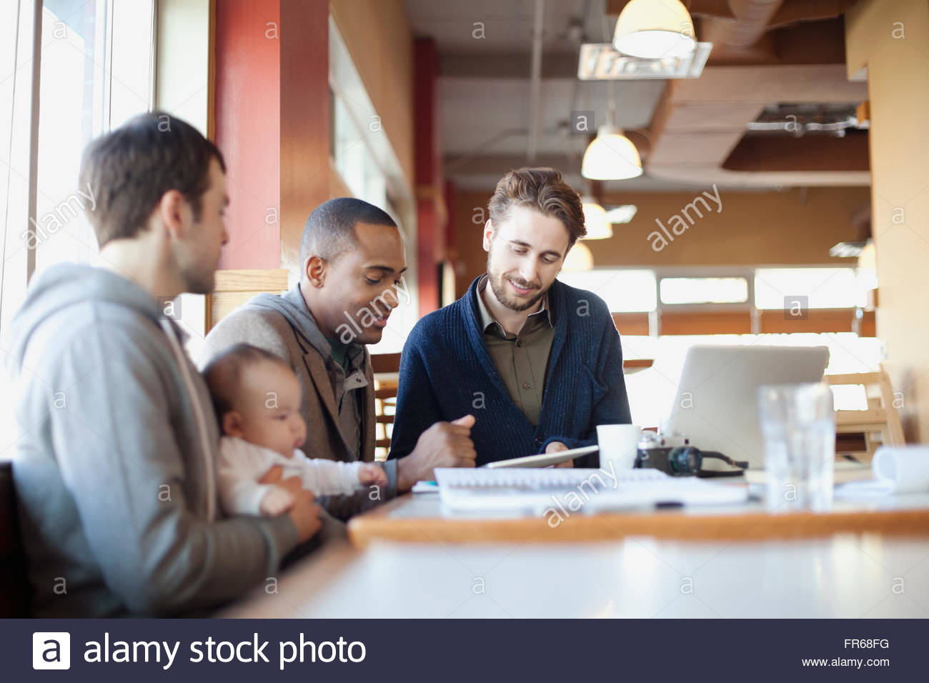 male friends in discussion at lunch Stock Photo