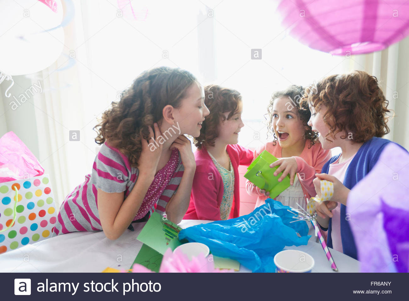 girls opening gifts at birthday party Stock Photo Alamy