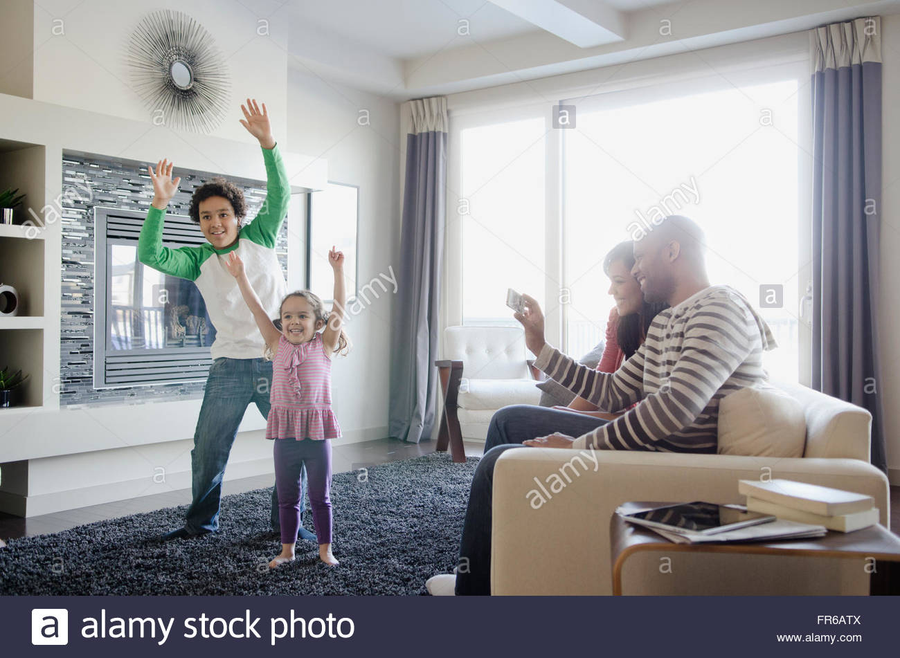 brother and sister playing motion sensing video game Stock Photo