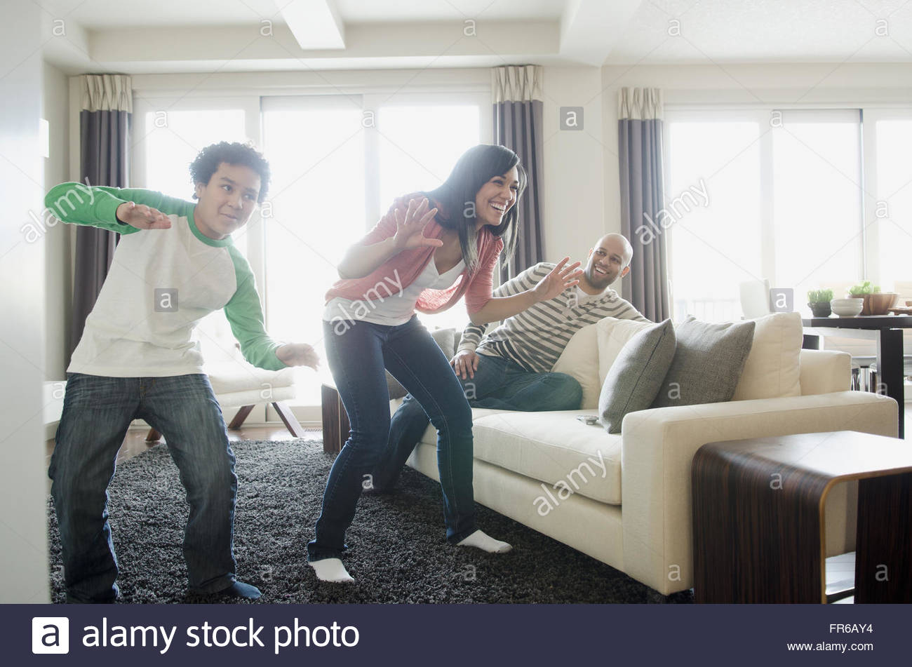 mom and son playing motion-sensing video game Stock Photo