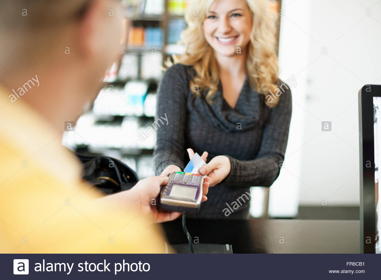 women paying for salon services Stock Photo Alamy