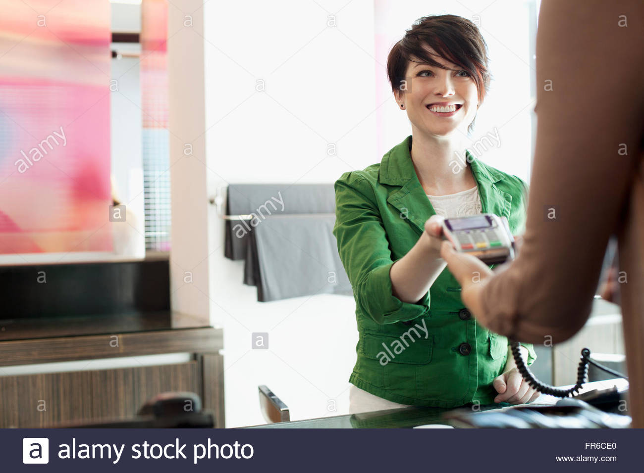 women paying for salon services Stock Photo Alamy