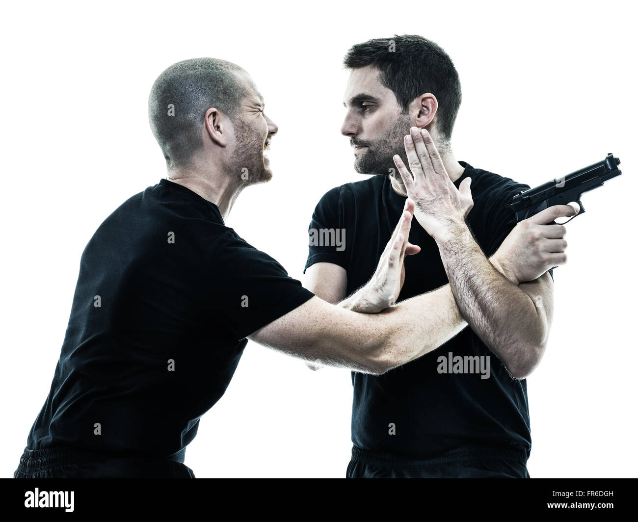 two caucasian men krav maga fighters fighting isolated silhouette on white background Stock Photo