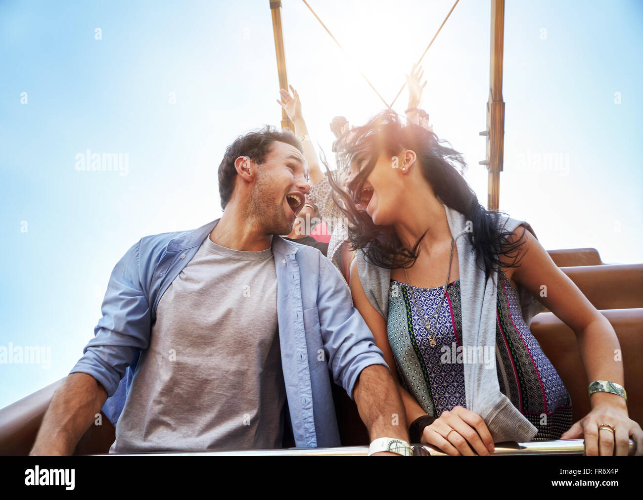 Exhilarated young couple on amusement park ride Stock Photo