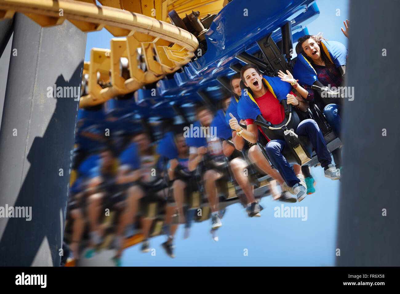 Young man screaming on amusement park ride Stock Photo