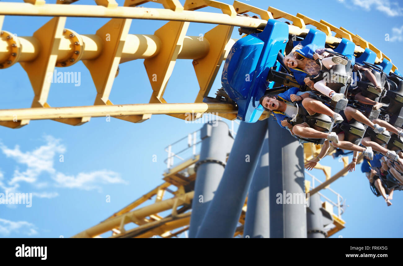 Friends riding amusement park ride Stock Photo