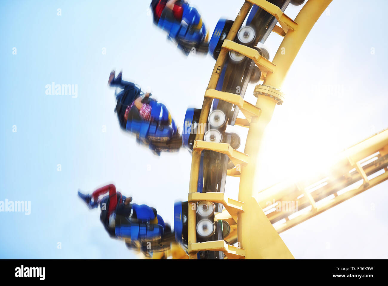 People flipping upside-down on amusement park ride Stock Photo