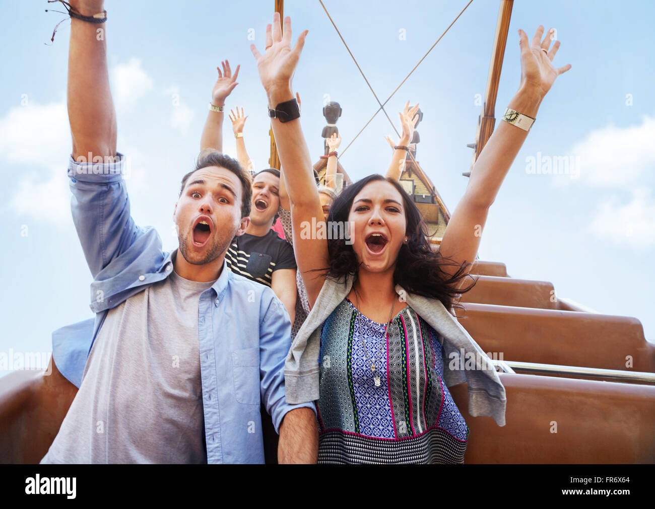 Portrait enthusiastic friends cheering on amusement park ride Stock ...