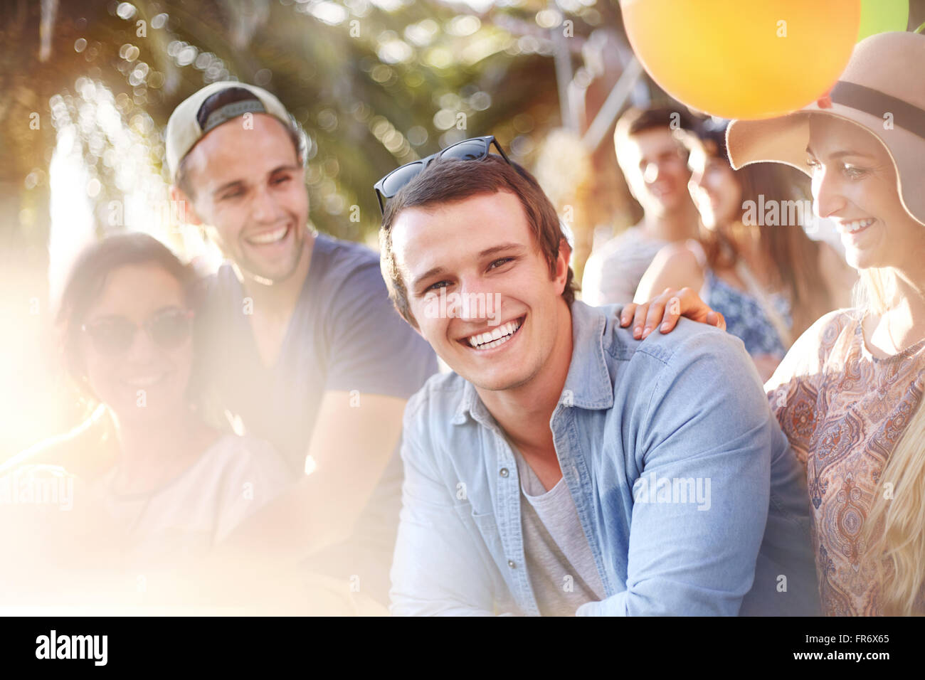 Portrait smiling young man with friends summer outdoors Stock Photo