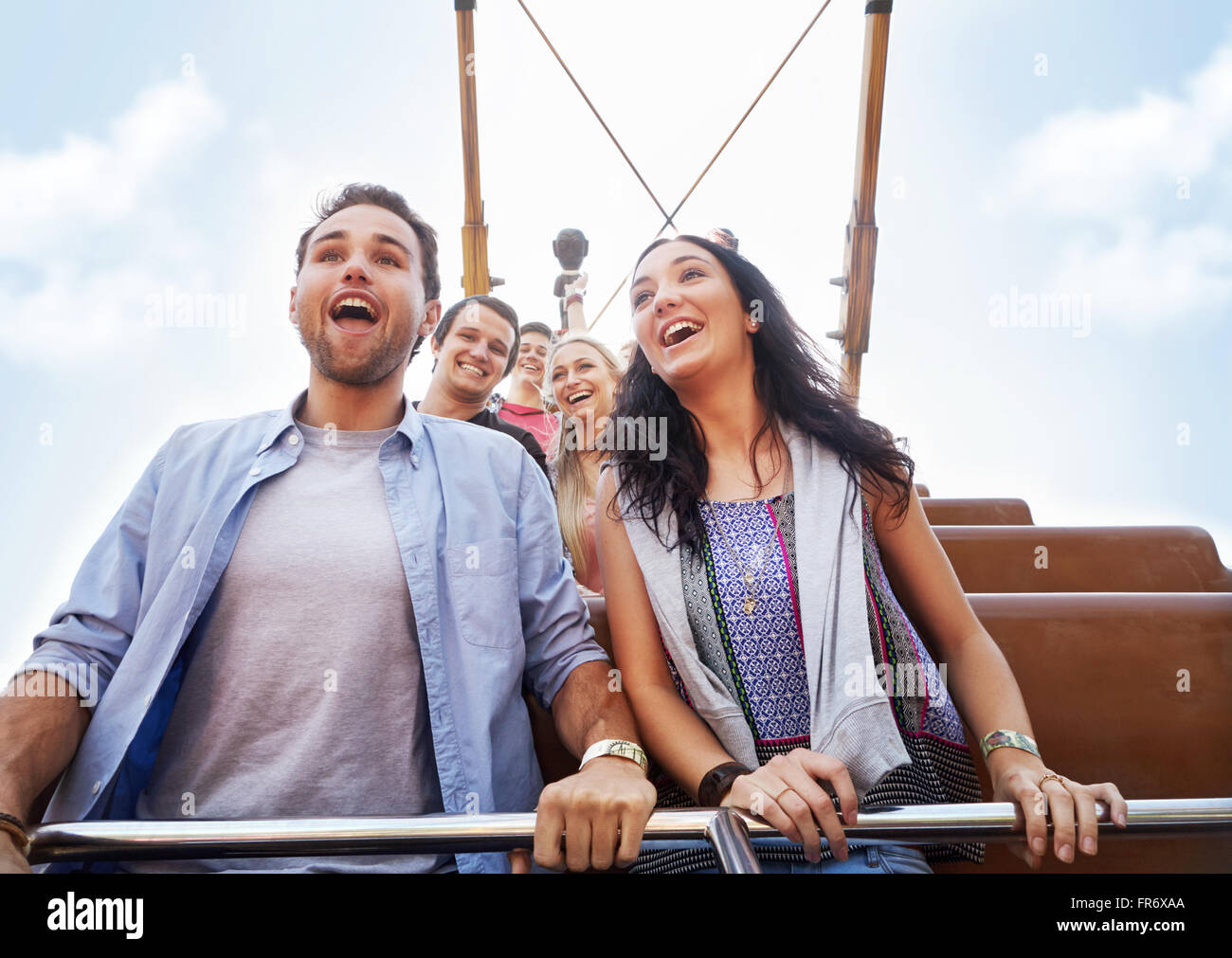 Enthusiastic couple riding amusement park ride Stock Photo