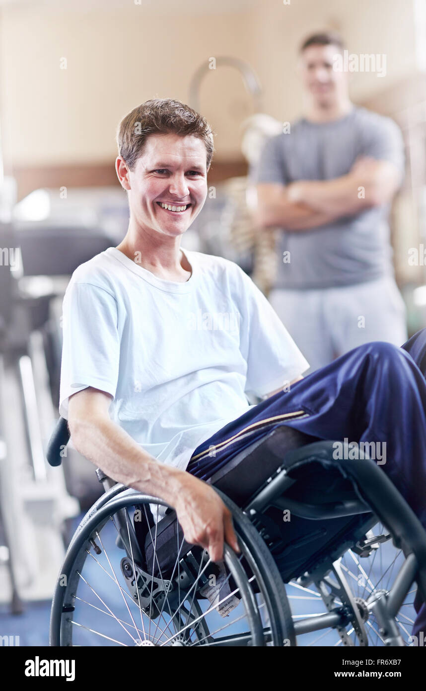 Portrait smiling man in wheelchair at physical therapy office Stock