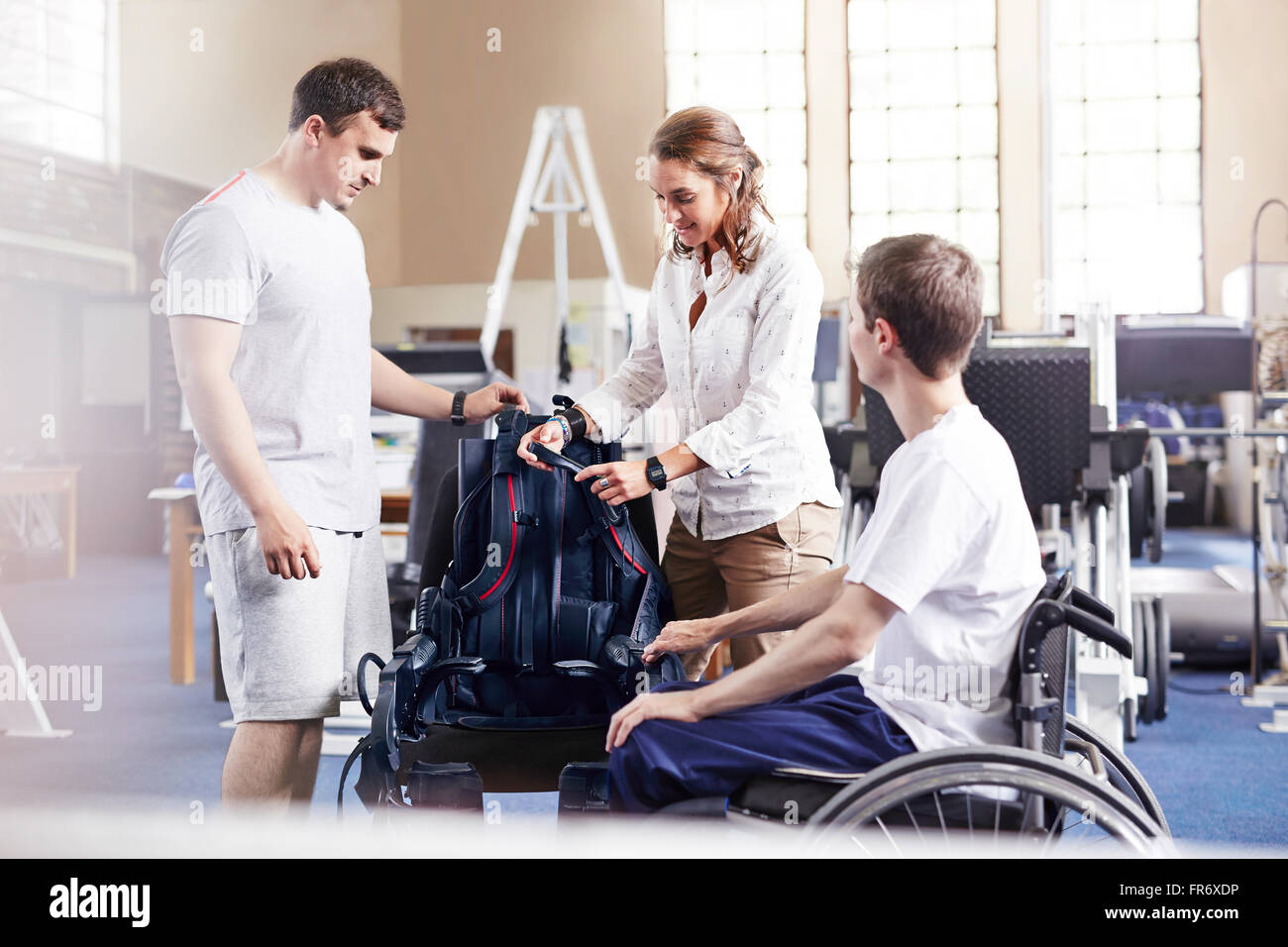 Physical therapists with man in wheelchair Stock Photo