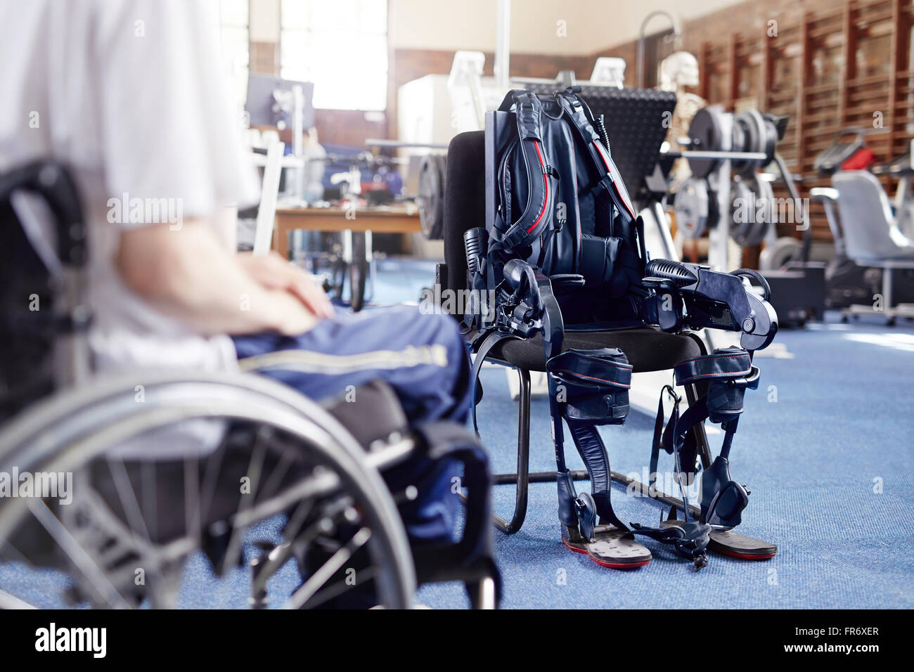 Man in wheelchair near physical therapy equipment Stock Photo