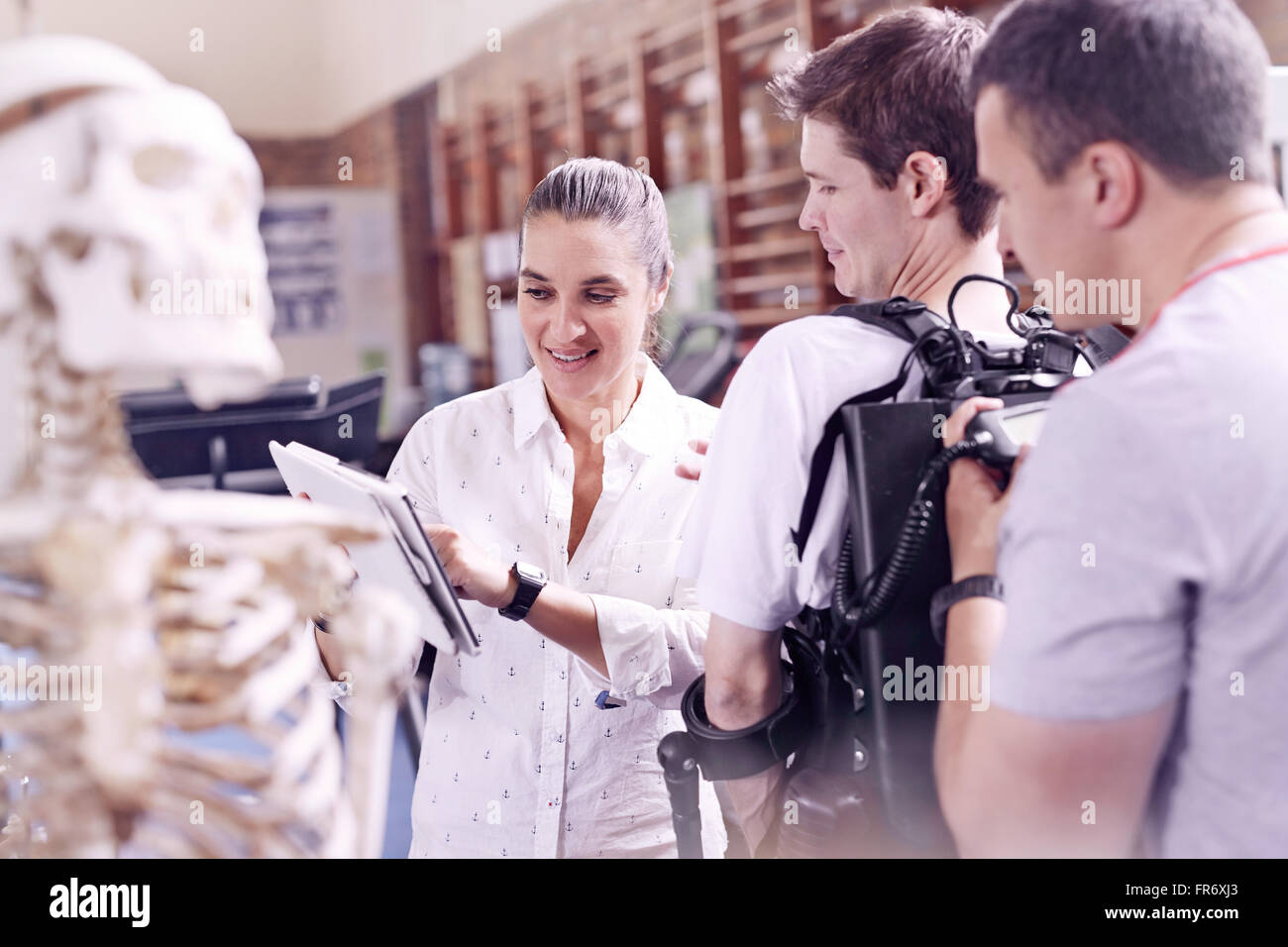 Physical therapist showing man digital tablet Stock Photo