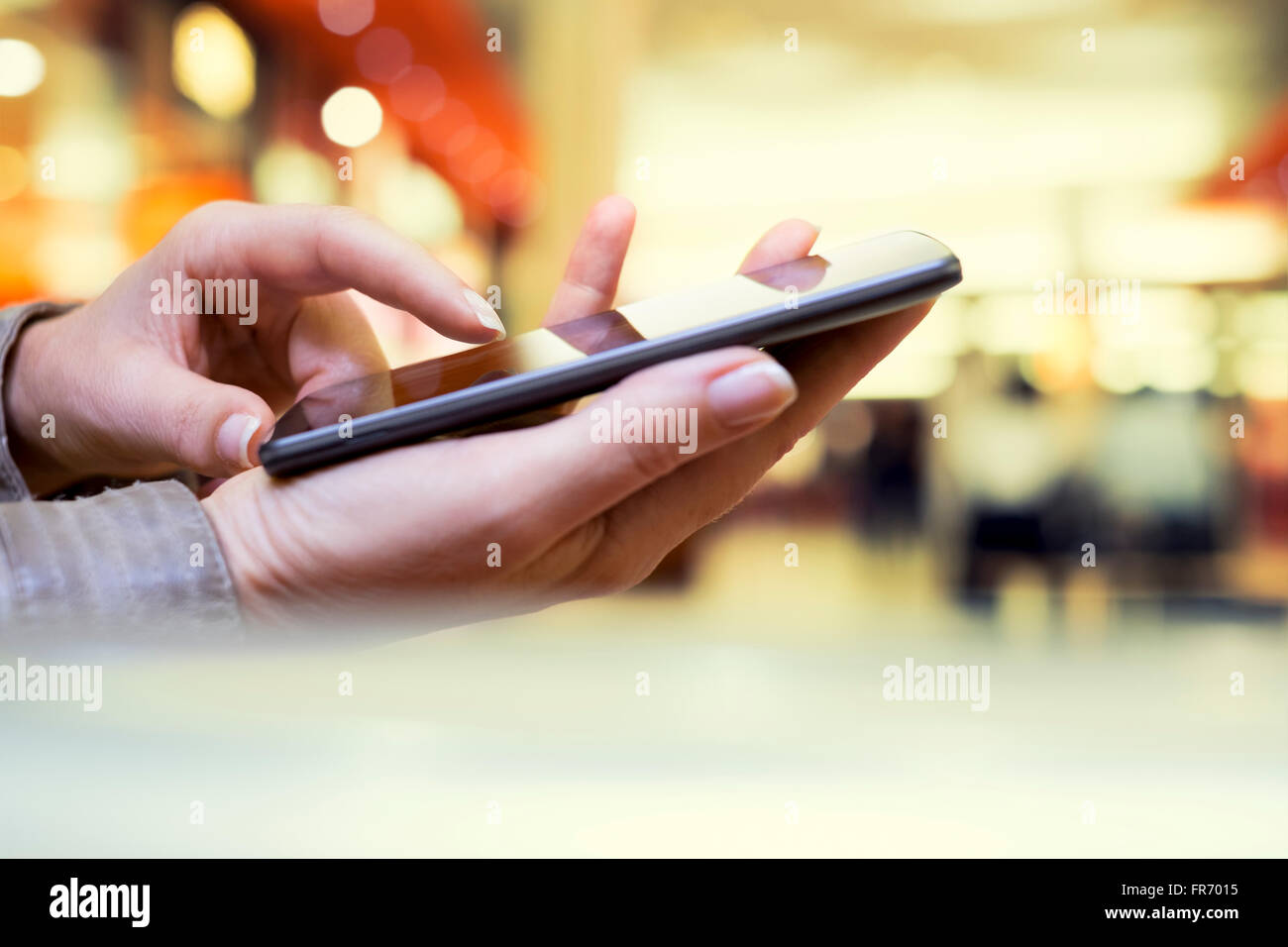 Woman texting on cell phone in mall. SMS message mail Stock Photo
