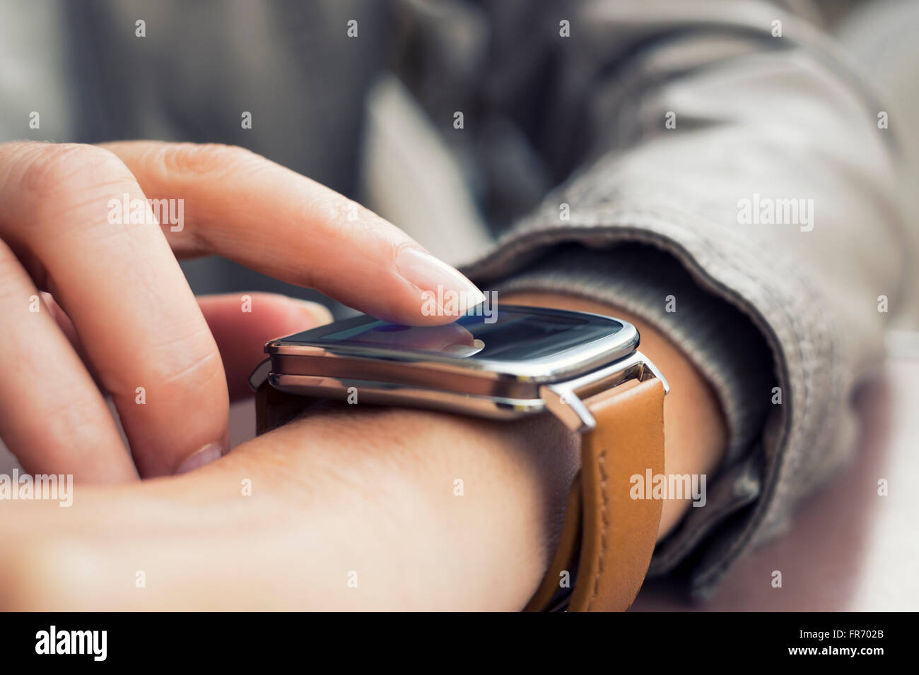 Closeup of hands woman using a smartwatch Stock Photo