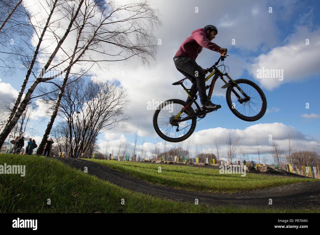 Cyclists using Cuningar Loop woodland park, in Rutherglen, Glasgow, Scotland Stock Photo