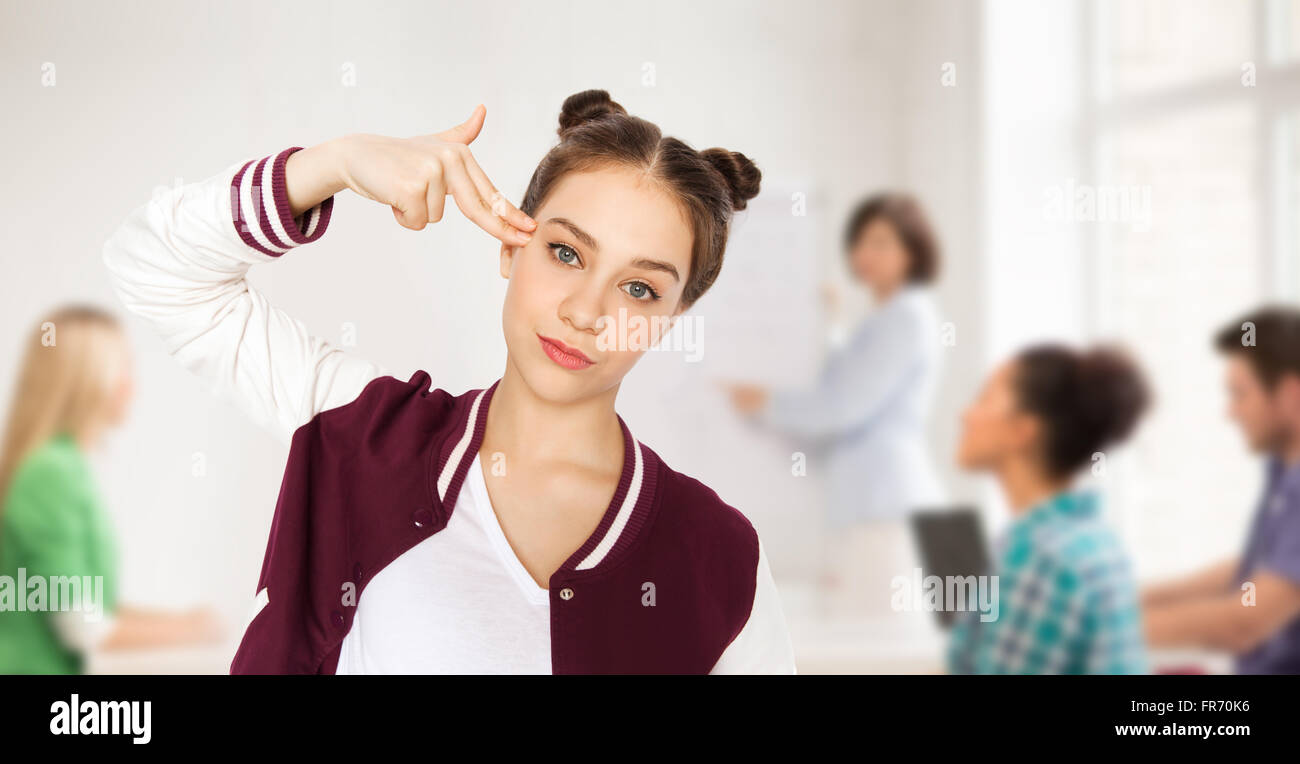bored student girl making finger gun gesture Stock Photo