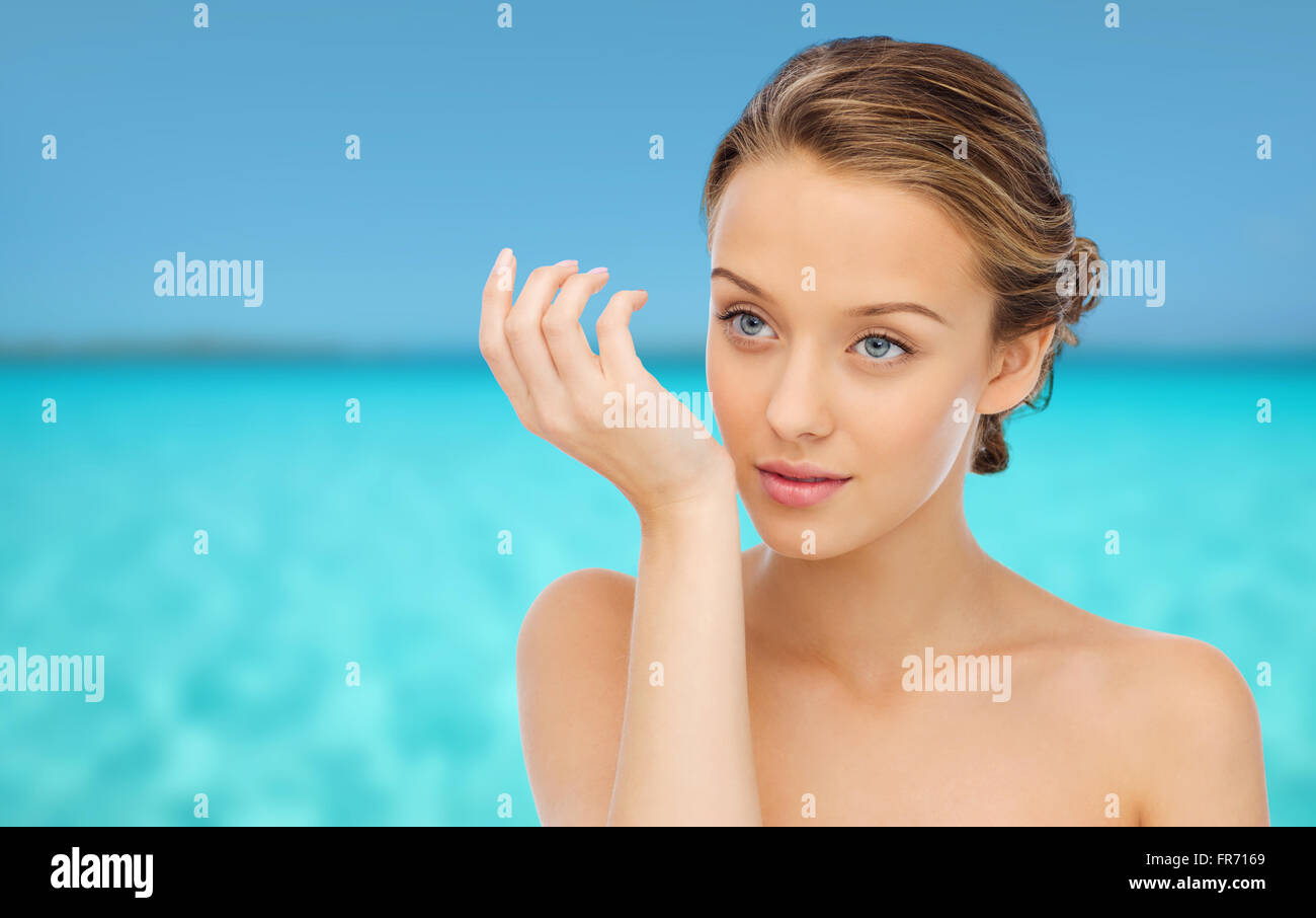 woman smelling perfume from wrist of her hand Stock Photo