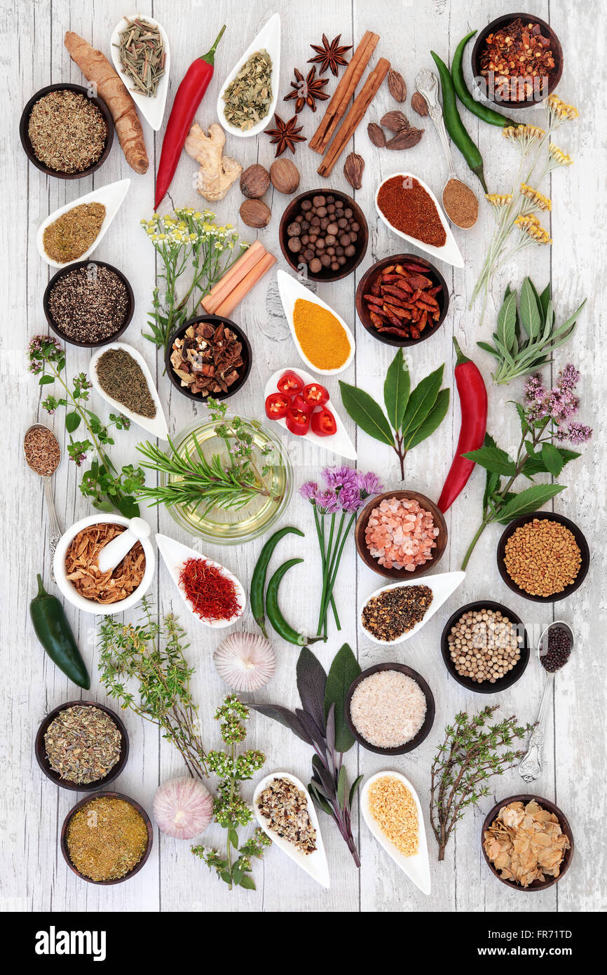 Large herb food seasoning sampler over distressed white wood background. Stock Photo