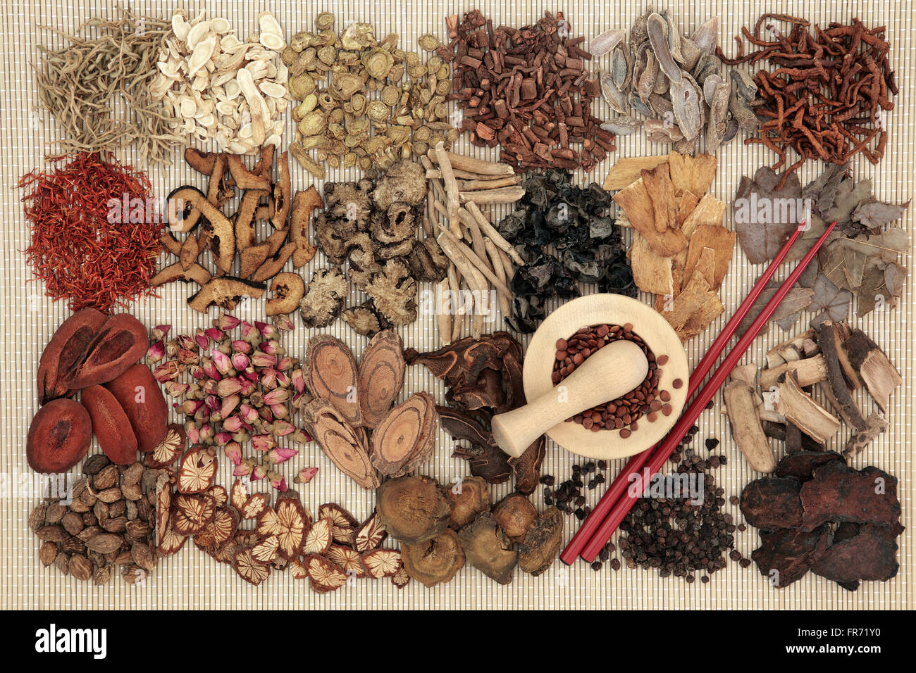 Traditional chinese herbal medicine ingredients over bamboo background