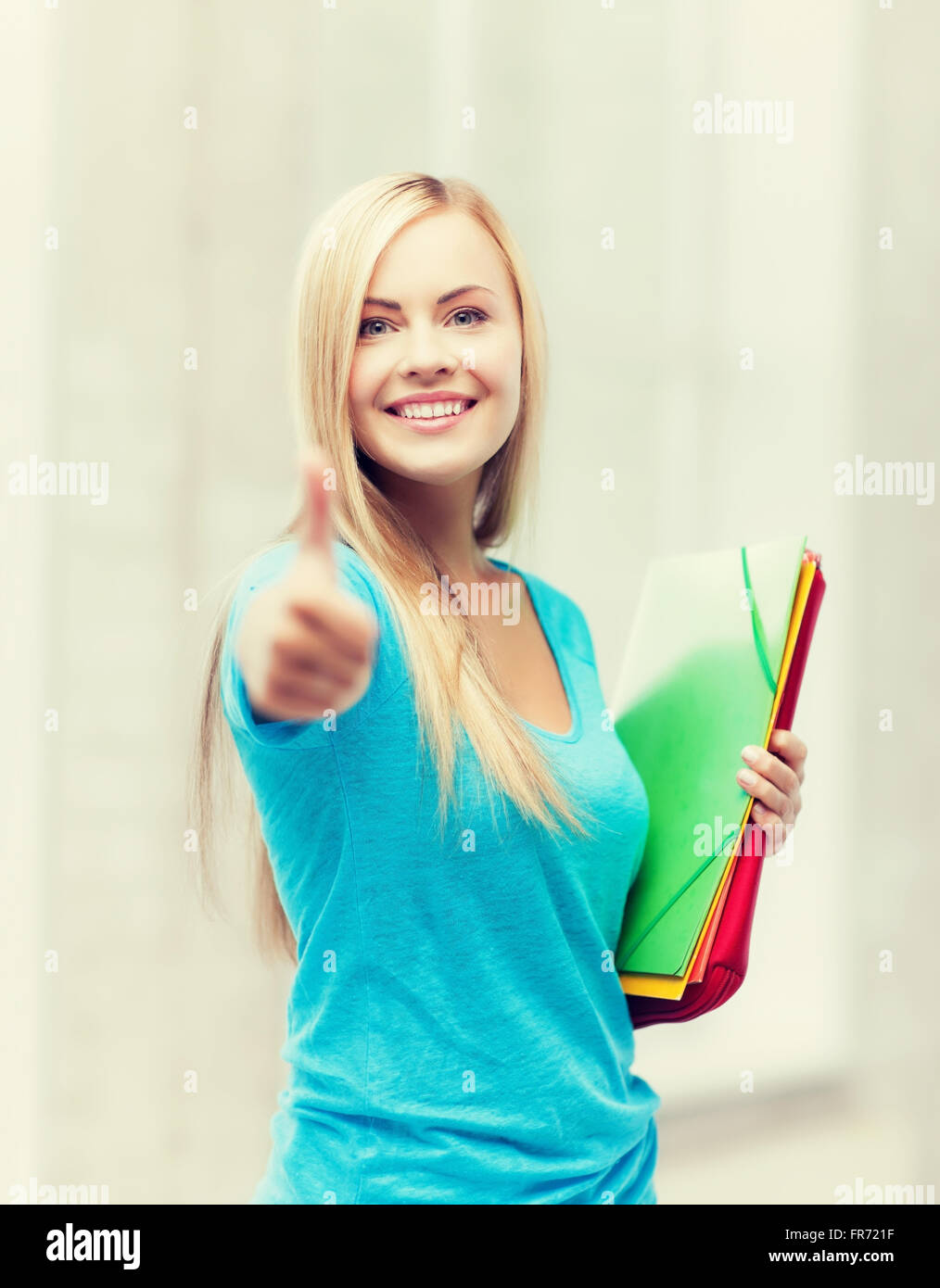 smiling student with folders Stock Photo - Alamy
